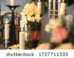 A funeral urn stands with lit candles in a cemetery chapel just before the funeral service.