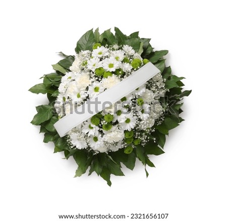 Funeral wreath of flowers with ribbon on white background, top view
