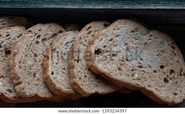 Fungus on the bread,Mold on\
bread covered with fungus,a piece of rye bread with white and black\
mold
