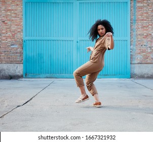 Funky Black Woman Dancing Alone In The Street. 
Attractive African Woman Dancing Smiling At The Camera.