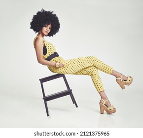 Funky cool. A young woman wearing a jumpsuit in the studio.