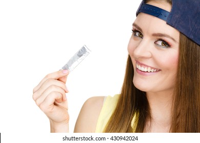 Funky People Concept. Young Woman With Chewing Gum. Bubble Gum Is In The Silver Paper. Girl Is Wearing Cap And Yellow Shirt.