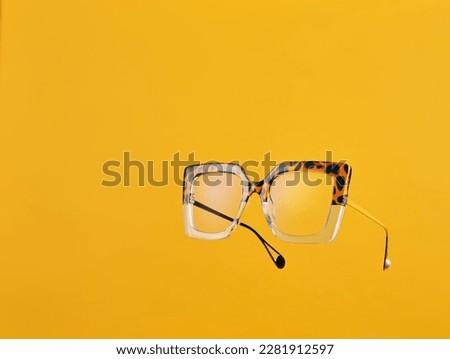Funky Tortoiseshell and Clear Seeing Glasses floating on Yellow Background