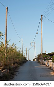 Funky Utility Poles and Wires Line a Greek Village Road