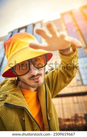 Similar – Man observing something through binoculars