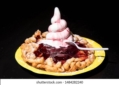 Funnel Cake With Strawberry Jam And Ice Cream At A Fair Ground Isolated On Black