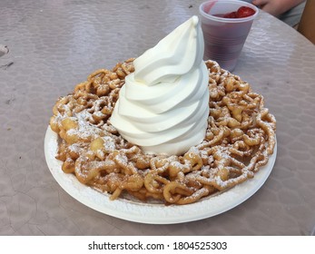 Funnel Cake Topped With Ice Cream At A Summer Fair