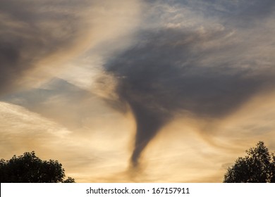 A Funnel Cloud Forming In The Sky Above