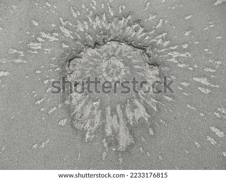 Funnel on the pavement from the explosion of a shell. A trace on the road from an artillery shot. Traces of the war on the asphalt road.