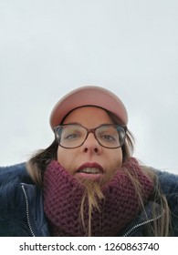 Funny, Accidental Selfie Portrait Of A Girl With Glasses, Scarf And Cap