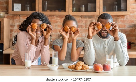 Funny African Family Having Good Time During Breakfast At Kitchen, Making Cupcake Eyes, Panorama