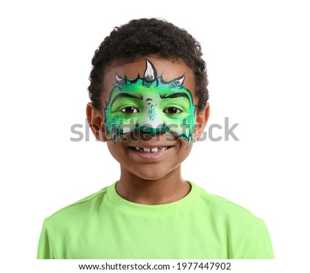Funny African-American boy with face painting on white background