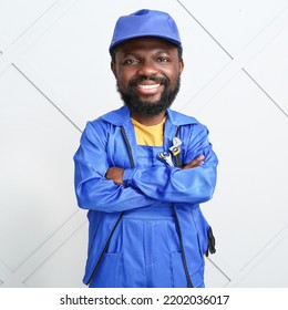 Funny African-American Car Mechanic With Big Head On Light Background 