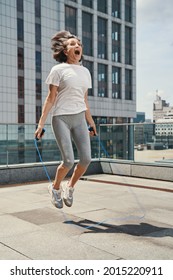 Funny Aged Female Jumping On Urban Roof