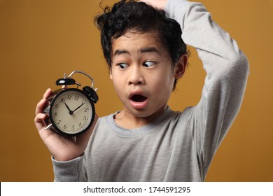 Funny Asian Boy Awake And Shocked Because It Is Too Late, Young Student Boy Worried To See Clock, Stunned Expression