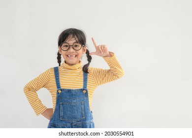 Funny Asian Child Girl Wearing Glasses On A White Background