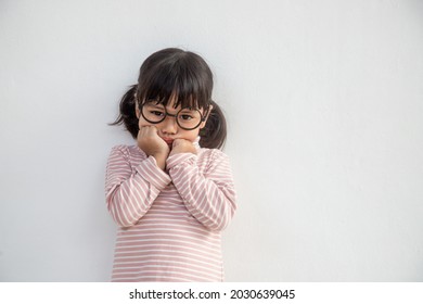 funny Asian child girl wearing glasses on a white background