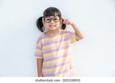 Funny Asian Child Girl Wearing Glasses On A White Background