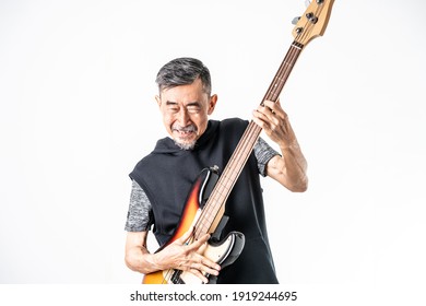 A funny Asian elder cool man has fashion in gray t-shirt And black vest play bass guitar. Shoot On white background in the studio. Positive active old cool senior healthy retirement concept.