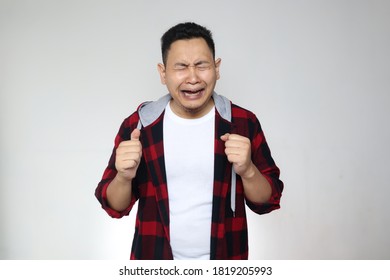Funny Asian man crying hard, sad depression frustration hopeless expression, against white background