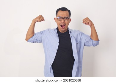 Funny Asian Man Shows Double Biceps Pose Pretending To Be A Strong Person Physically And Mentally, Showing Self Confidence