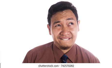 Funny Asian man smiling and thinking. Close up face portrait expression isolated over white background