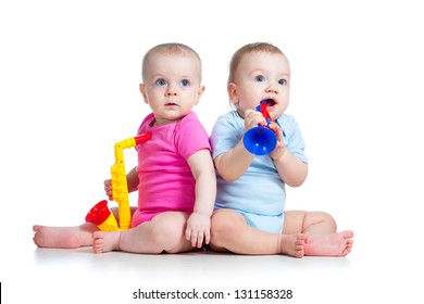 Funny babies girl and boy  play musical toys isolated