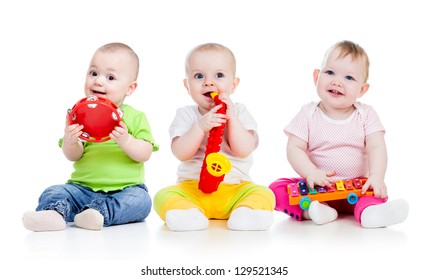 Funny babies girls  group with musical toys isolated
