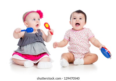 Funny babies girls  with musical toys. Isolated on white