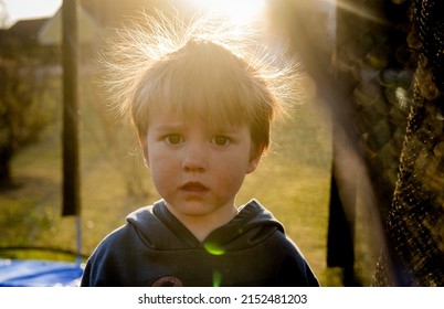 Funny Baby Boy With Hair Static. Back Light. Kid With Big Eyes And Funny Hairdo