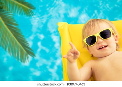 Funny Baby Boy On Summer Vacation. Child Having Fun In Swimming Pool