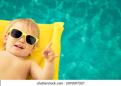 Funny Baby Boy On Summer Vacation. Kid Having Fun In Swimming Pool