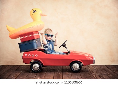 Funny Baby Boy Playing At Home. Summer Vacation And Travel Concept