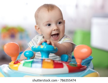 Funny Baby Boy Playing In Baby Jumper