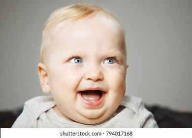 Funny Baby With Evil Genius Laugh Portrait Photo