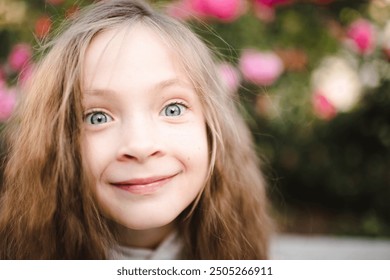 Funny baby girl with blonde hair smiling and looking at camera close up. Childhood.  - Powered by Shutterstock