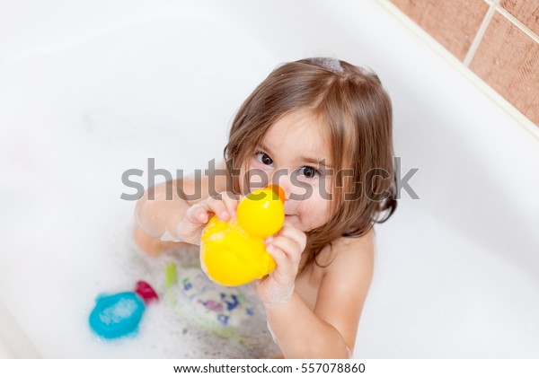 Non-Professional plays in baths with a toy