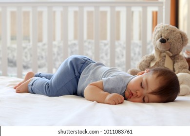 Funny Baby Sleeping On His Stomach On Bed At Home. Child Daytime Bottom Up Sleeping Position