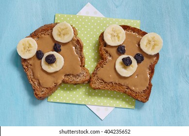 Funny bear face sandwich with peanut butter, banana and raisins