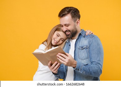 Funny bearded man in casual clothes have fun with cute child baby girl. Father little kid daughter isolated on yellow background in studio. Love family day parenthood childhood concept. Reading book - Powered by Shutterstock