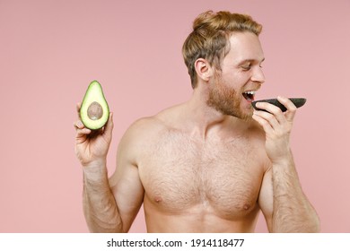 Funny Bearded Naked Young Man 20s Years Old Perfect Skin Hold Eating Half Of Fresh Avocado Fruit Isolated On Pastel Pink Background Studio Portrait. Skin Care Healthcare Cosmetic Procedures Concept