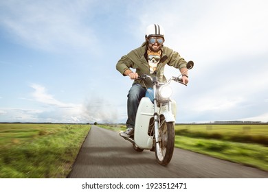 Funny Biker Riding A Moped With His Dog