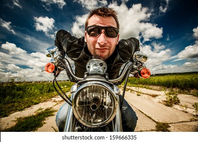 Funny Biker In Sunglasses And Leather Jacket Racing On The Road (fisheye Lens)