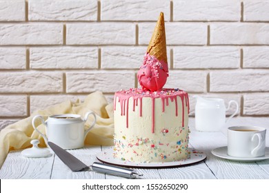 Funny Birthday Cake With Melted Ice Cream In Waffle Cone And Drip Frosting With A Brick Wall At The Background