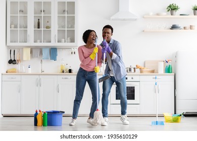 Funny Black Couple Singing Songs While Cleaning Kitchen, Copy Space