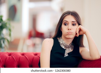Funny Bored Elegant Woman Waiting in Hotel Lobby. Unhappy stood-up girl tired of waiting on a couch
