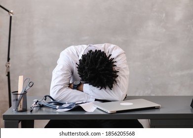 Funny bored at work african american doctor worker falling asleep at office desk, employee sleeping at workplace near laptop feel overworked concept - Powered by Shutterstock