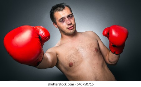 Funny Boxer Man In Knockout Over Dark Gray Background. Comic Weak Fighter With Red Sport Boxing Gloves. Waist Up Humorous Kickboxer