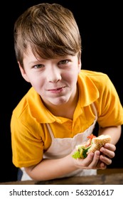 Funny Boy Eating Sandwich, Isolated On Black Background