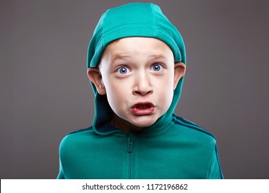 Funny boy in Hood. cute kid with big ears. funny grimaced emotion child